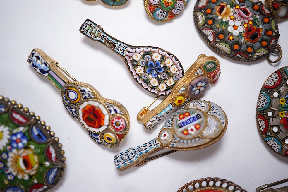 Thirty-one costume micro-mosaic brooches, to include seventeen guitar and banjo shaped brooches, five large oval/ circular brooches including scenic swan brooch, eight, smaller brooches and a pendant. Condition - fair/go